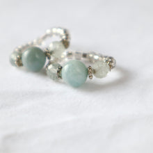 Load image into Gallery viewer, Stack of silver rings with aquamarine gemstones on a white background