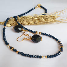Load image into Gallery viewer, Navy blue beaded necklace with gold accents and navy beads on a white background