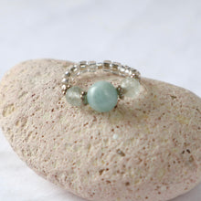 Load image into Gallery viewer, Silver ring with aquamarine with light blue beads on a pebble