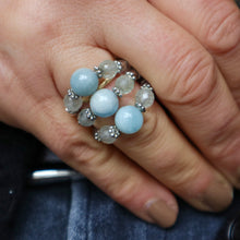 Load image into Gallery viewer, Close-up of a hand wearing a ring with blue beads and silver accents.