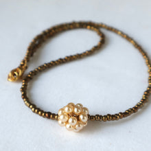 Load image into Gallery viewer, Necklace with gold and pearl bead design on a white background