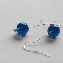 Load image into Gallery viewer, Pair of blue beaded earrings on a light gray background