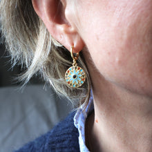 Load image into Gallery viewer, Close-up of a person wearing a gold earring with blue gemstone