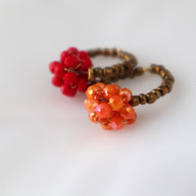 Load image into Gallery viewer, Two beaded rings with red and orange beads on a white background