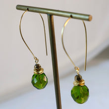 Load image into Gallery viewer, Green beaded earrings on a gold earring stand against a white background