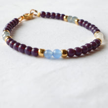 Load image into Gallery viewer, Beaded bracelet with purple, gold, and blue beads on a white background