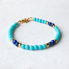 Load image into Gallery viewer, Beaded bracelet with blue and gold accents on a white background