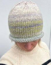 Load image into Gallery viewer, Person wearing a knitted hat with gray and green stripes against a plain background