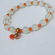 Load image into Gallery viewer, Beaded bracelet with white and orange beads on a white background