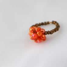 Load image into Gallery viewer, Beaded ring with orange and brown beads on a light gray background