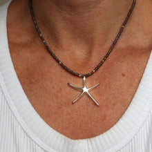 Load image into Gallery viewer, Starfish pendant necklace on a person wearing a white top