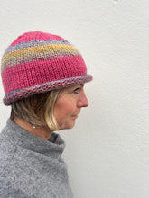 Load image into Gallery viewer, Person wearing a colorful knit hat against a plain background