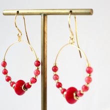 Load image into Gallery viewer, Gold hoop earrings with red beads on a gold stand against a white background