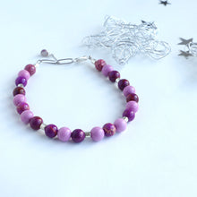 Load image into Gallery viewer, A purple magnesite bracelet with silver plating and crackle design, alongside an extender chain, displayed on a white background with decorative silverware in the background.